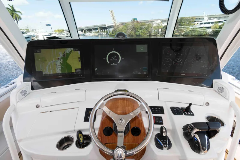 Slide: The Image of Helm of 2021 HCB 53 Sueños boat with advanced navigation displays and controls. - 11