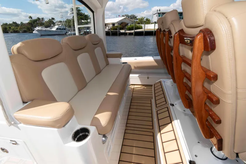 Slide: The Image of Luxurious seating on 2021 HCB 53 Sueños boat, featuring beige upholstery and wooden accents. - 14