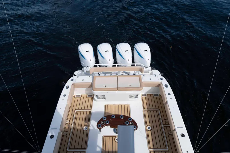 Slide: The Image of 2021 HCB 53 Sueños boat with four engines, teak deck, and spacious seating area. - 25