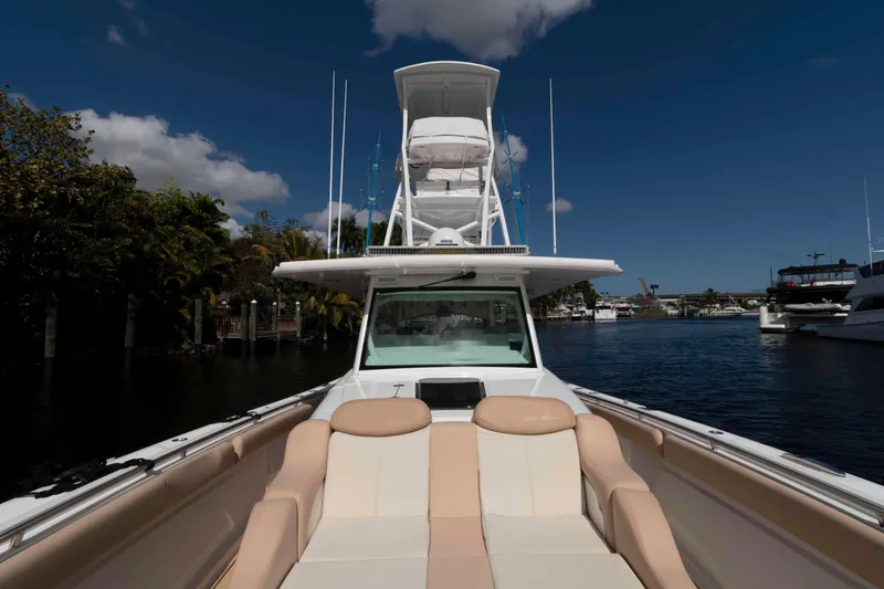 Slide: The Image of 2021 HCB 53 Sueños boat with spacious seating, docked under a clear blue sky. - 27