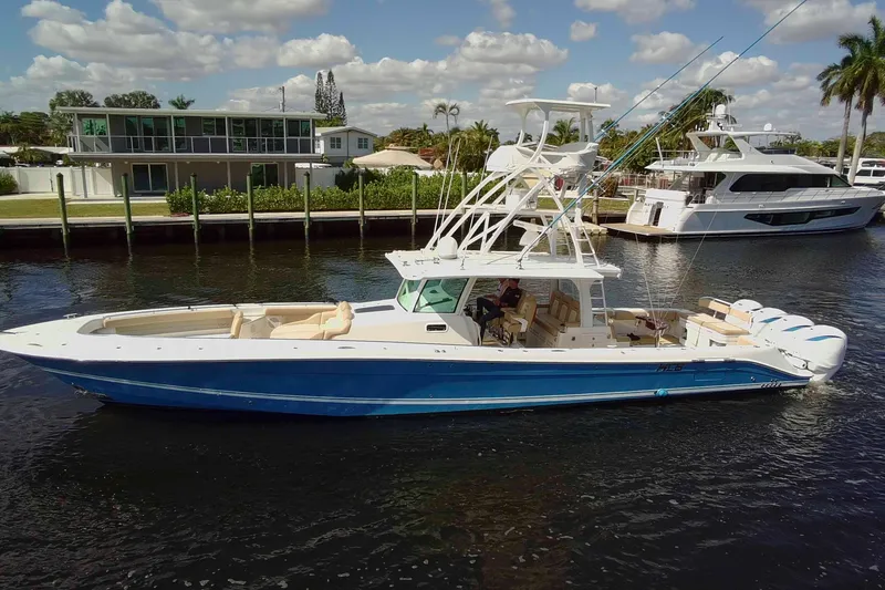Slide: The Image of 2021 HCB 53 Sueños boat on a sunny day, docked near waterfront homes. - 3