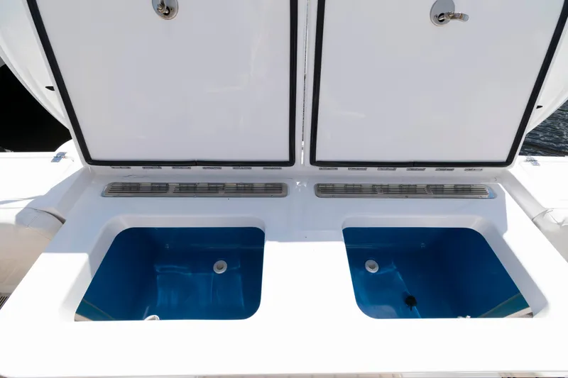 Slide: The Image of 2021 HCB 53 Sueños boat with open storage compartments on deck. - 31