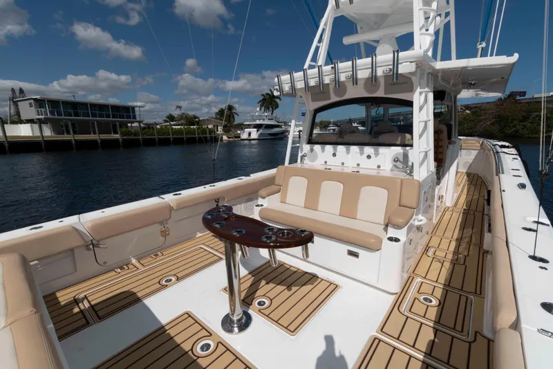 Slide: The Image of Luxurious 2021 HCB 53 Sueños boat interior with beige seating and wooden deck. - 4