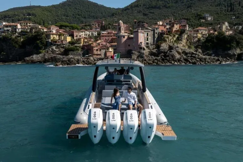 Slide: The Image of 2026 Ranieri CAYMAN 50.0 HARD TOP cruising near scenic coastal village. - 3