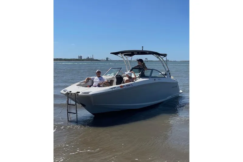 Slide: The Image of 2021 Cobalt 25SC boat with passengers enjoying a sunny day on the water. - 15