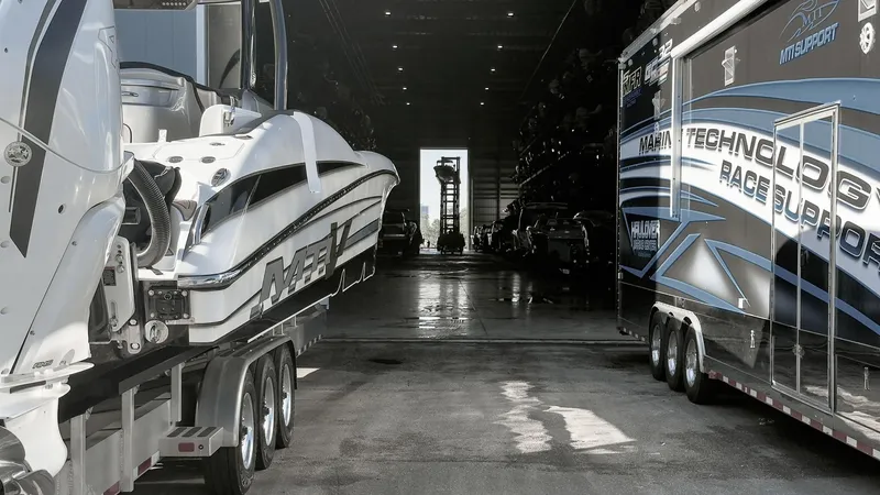 Slide: The Image of 2022 MTI V50 boat and trailer in a dimly lit storage facility. - 36