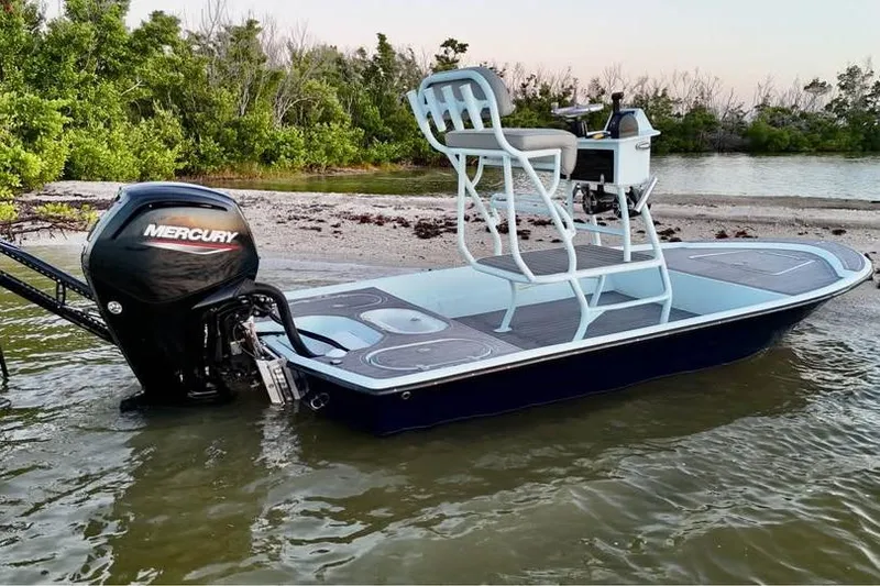 Slide: The Image of 2001 Pro Sports 16 boat with Mercury engine, docked near a sandy shore. - 4
