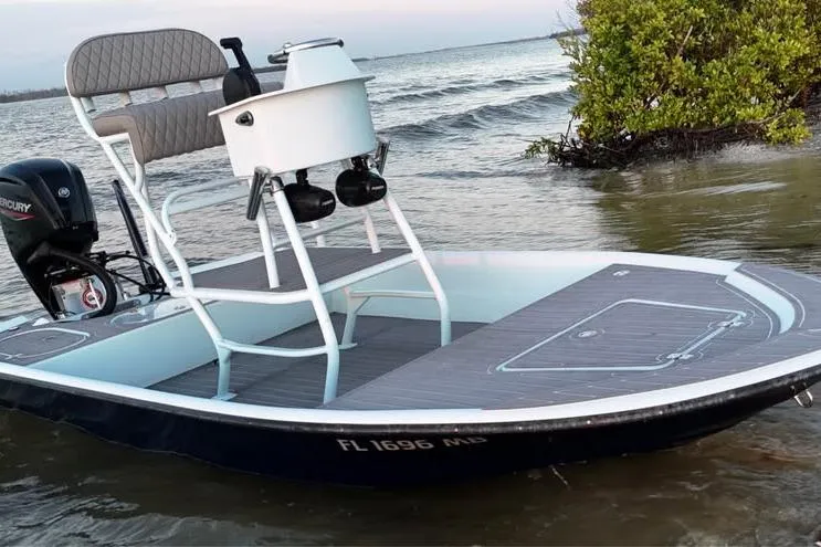 Slide: The Image of 2001 Pro Sports 16 boat with Mercury engine on calm water near shoreline. - 5