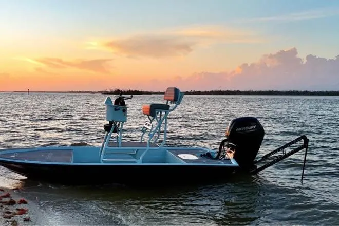 Slide: The Image of Pro Sports 16 boat from 2001 on calm water at sunset. - 6