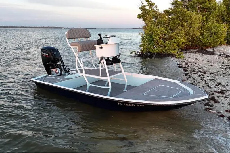 Slide: The Image of 2001 Pro Sports 16 boat with Mercury engine, docked near shoreline, calm waters. - 8