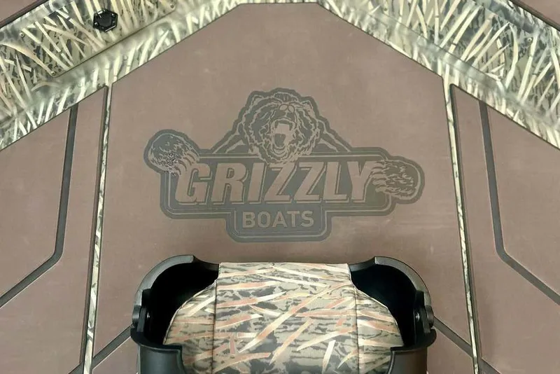 Slide: The Image of 2026 Tracker Grizzly 1754 SC boat deck with camo design and logo. - 15