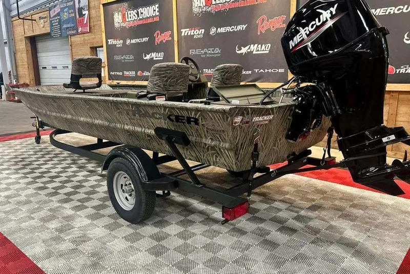 Slide: The Image of 2026 Tracker Grizzly 1754 SC boat with Mercury engine on display in showroom. - 2