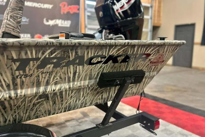 Slide: The Image of 2026 Tracker Grizzly 1754 SC boat with camouflage design on a trailer. - 4