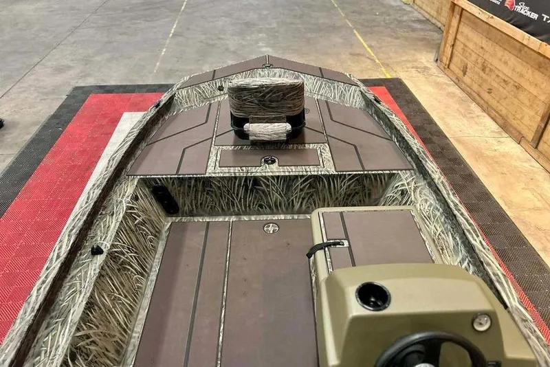 Slide: The Image of 2026 Tracker Grizzly 1754 SC boat interior with camouflage design and steering console. - 5