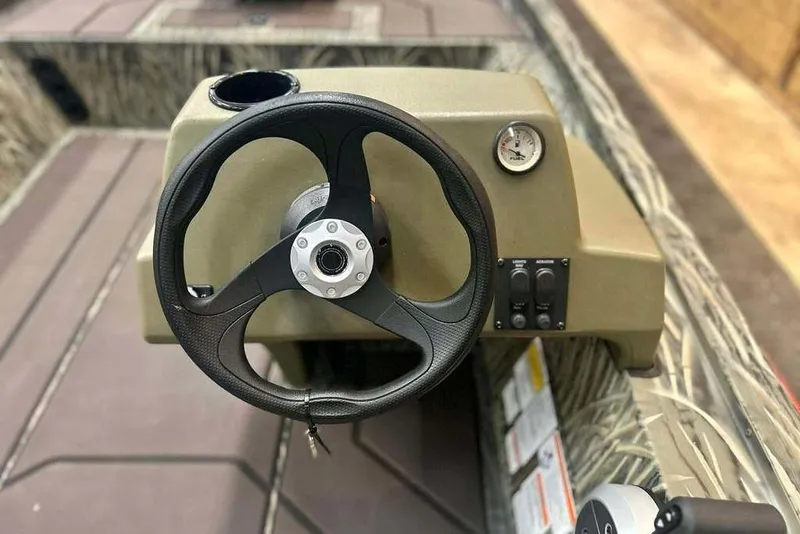 Slide: The Image of Steering console of 2026 Tracker Grizzly 1754 SC boat with gauge and controls. - 8