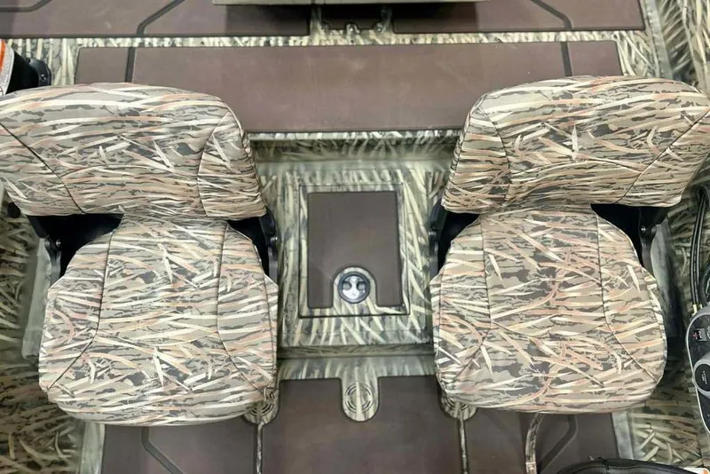 Slide: The Image of 2026 Tracker Grizzly 1754 SC boat interior with camo-patterned seats and flooring. - 9