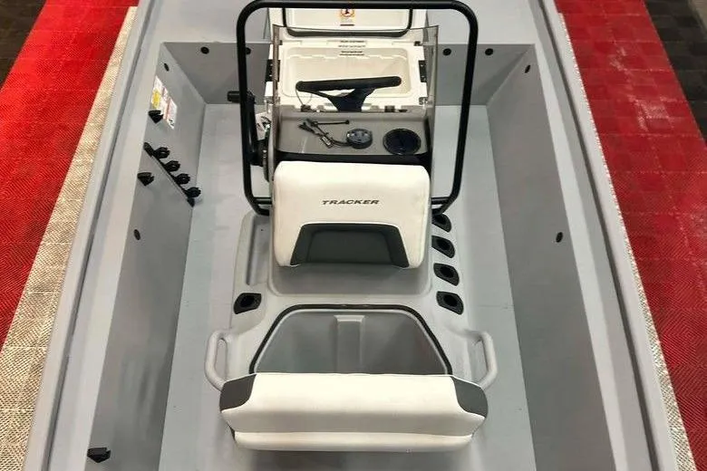 Slide: The Image of 2026 Tracker Bass Tracker Classic CC boat interior with steering console and seating. - 11