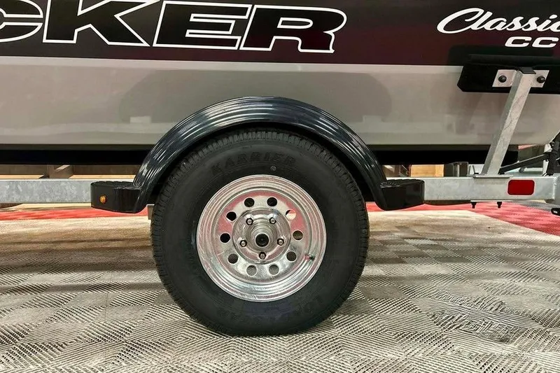 Slide: The Image of 2026 Tracker Bass Tracker Classic CC trailer wheel and fender on display. - 14