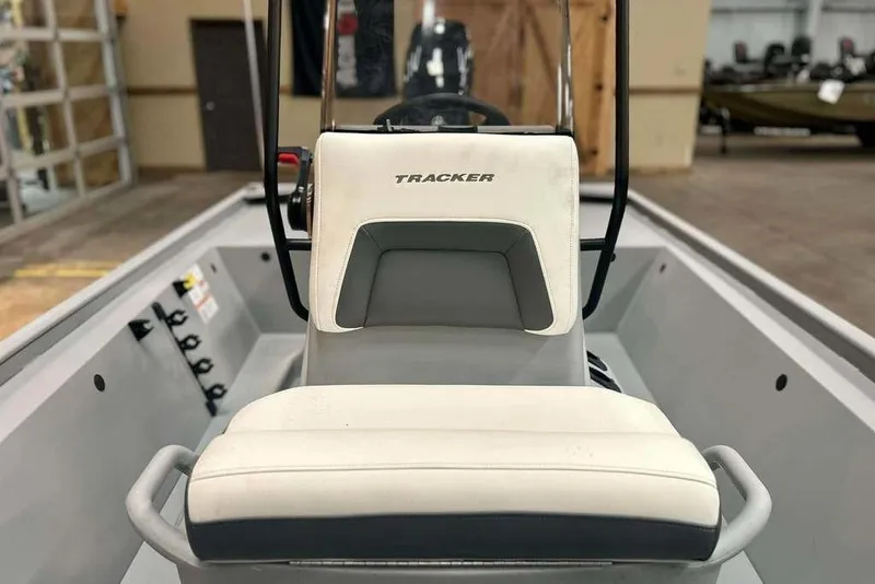 Slide: The Image of 2026 Tracker Bass Tracker Classic CC boat interior with steering console and seating. - 19