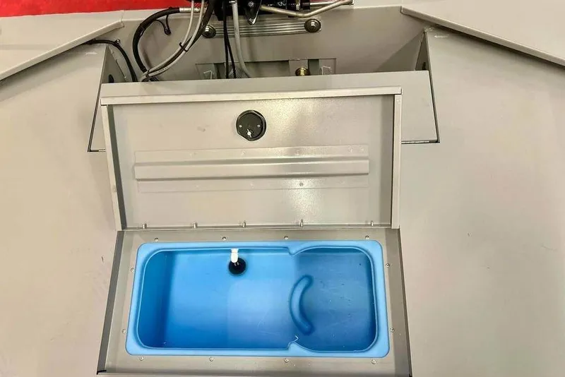 Slide: The Image of 2026 Tracker Bass Tracker Classic CC livewell with blue interior and open lid. - 20