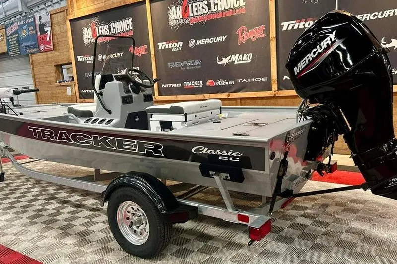 Slide: The Image of 2026 Tracker Bass Tracker Classic CC boat with Mercury engine on display. - 3