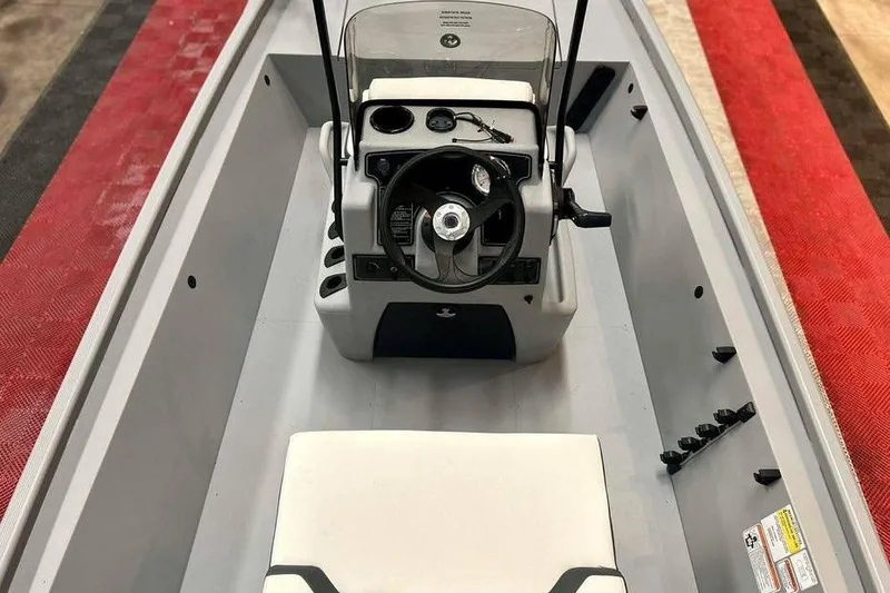 Slide: The Image of 2026 Tracker Bass Tracker Classic CC boat interior with steering console and seating. - 9