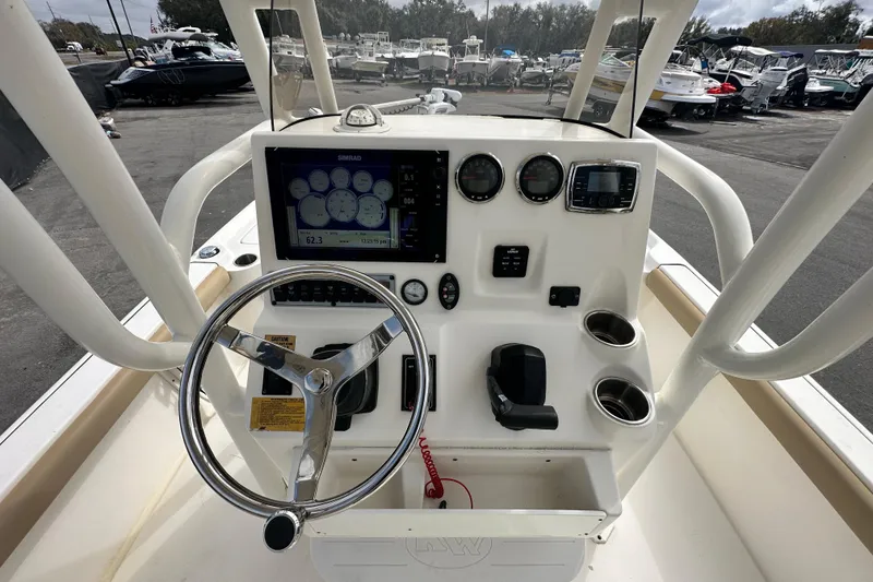 Slide: The Image of 2018 Key West 210 Bay Reef boat dashboard with steering wheel and navigation instruments. - 14