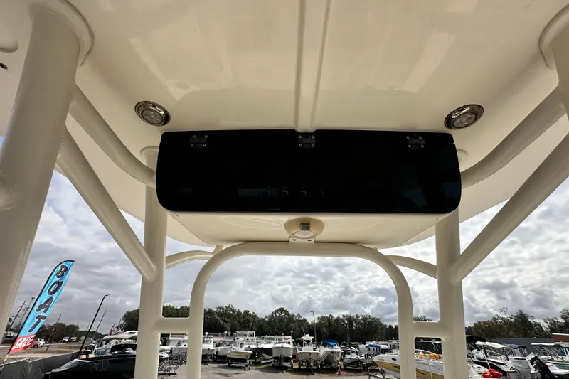 Slide: The Image of 2018 Key West 210 Bay Reef boat interior view with overhead console and outdoor setting. - 16