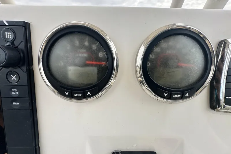 Slide: The Image of Dashboard of a 2018 Key West 210 Bay Reef boat with gauges and controls. - 19