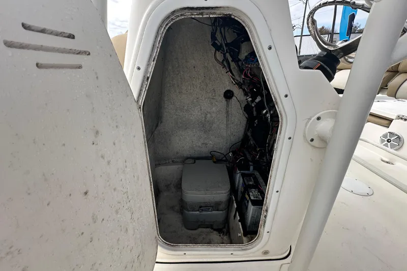 Slide: The Image of 2018 Key West 210 Bay Reef boat storage compartment with wiring and battery. - 24
