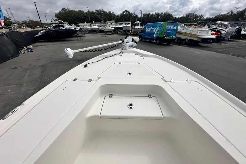 Slide: The Image of 2018 Key West 210 Bay Reef boat at marina, overcast sky, parked vessels in background. - 28