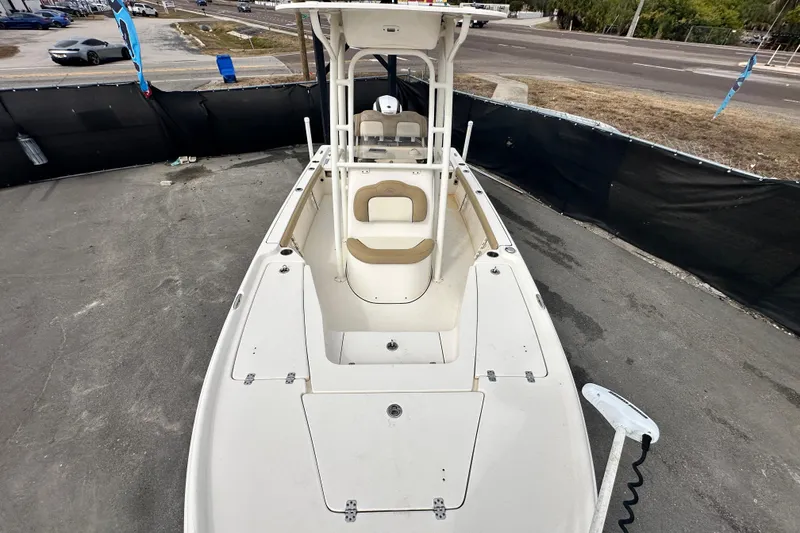 Slide: The Image of 2018 Key West 210 Bay Reef boat, white exterior, parked on pavement near a road. - 41