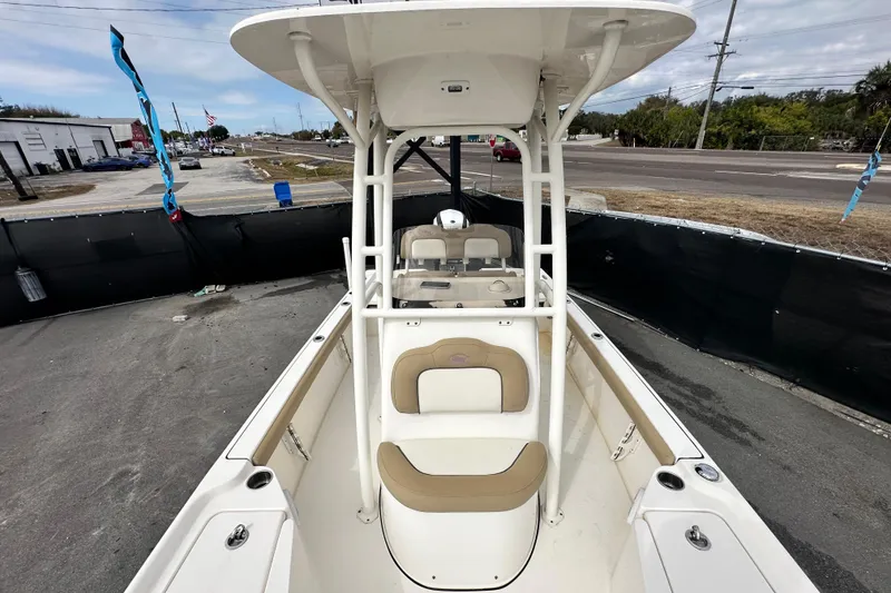 Slide: The Image of 2018 Key West 210 Bay Reef boat with seating and console, displayed outdoors. - 43