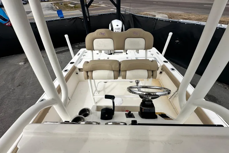 Slide: The Image of 2018 Key West 210 Bay Reef boat interior with steering wheel and seating. - 44