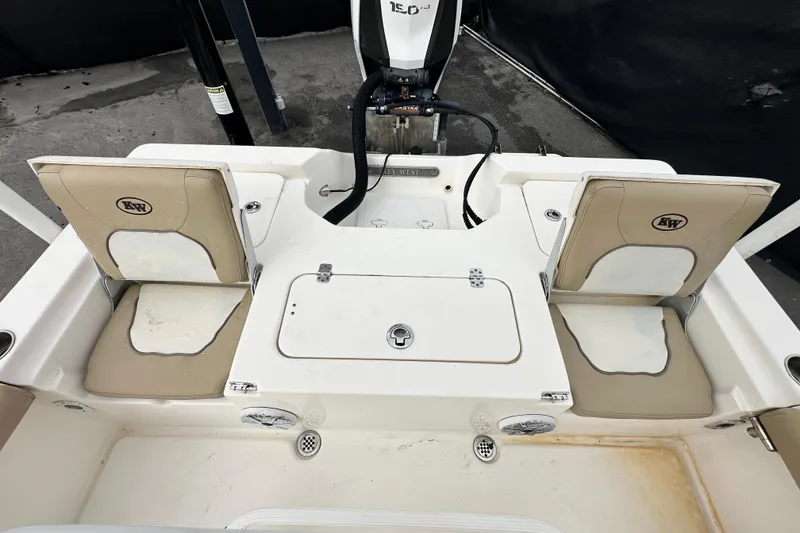 Slide: The Image of 2018 Key West 210 Bay Reef boat interior with seating and storage compartments. - 48