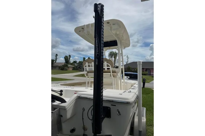 Slide: The Image of 2018 Key West 210 Bay Reef boat with Evinrude engine on trailer, under cloudy sky. - 5