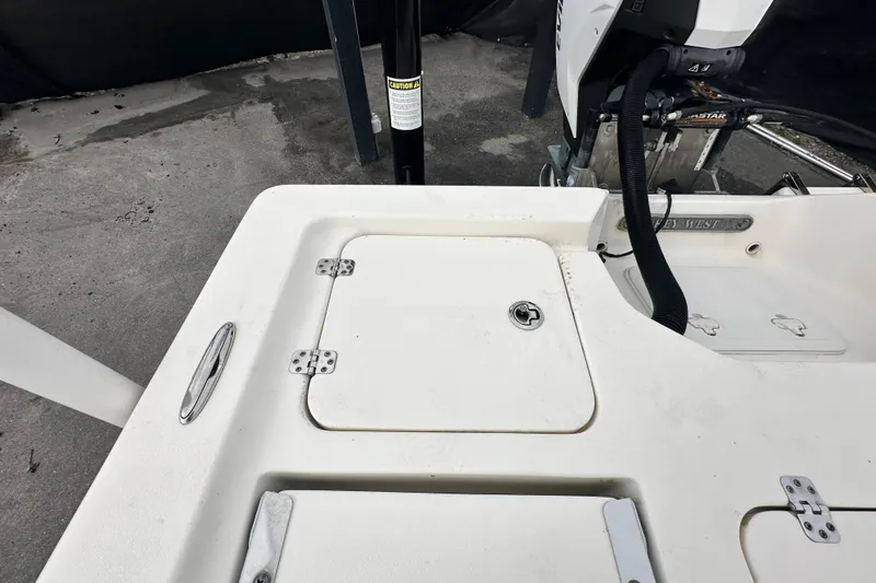 Slide: The Image of 2018 Key West 210 Bay Reef boat deck with storage compartment and engine view. - 50