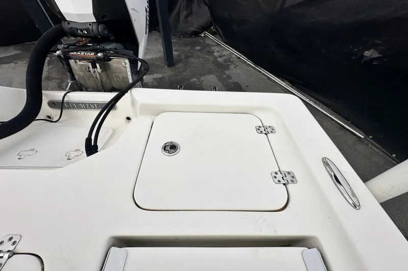 Slide: The Image of 2018 Key West 210 Bay Reef boat deck with storage compartment and motor. - 51