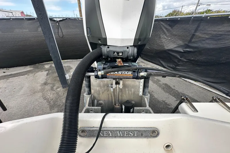 Slide: The Image of 2018 Key West 210 Bay Reef boat engine and steering system close-up. - 56