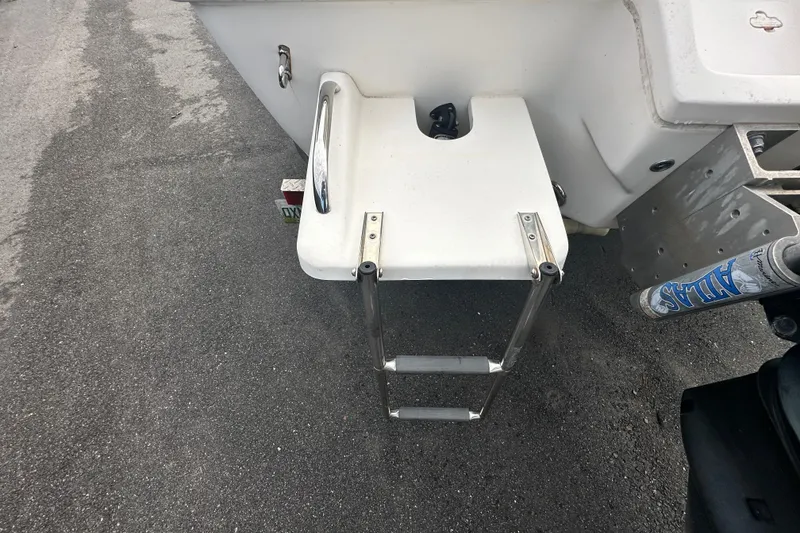 Slide: The Image of 2018 Key West 210 Bay Reef boat with foldable swim ladder on asphalt surface. - 59