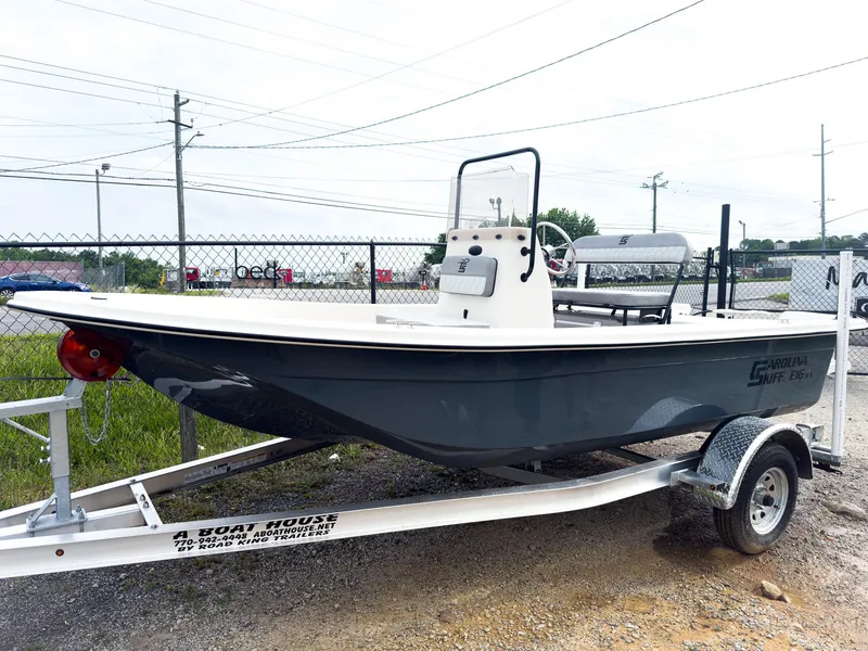 The Image of 2025 Carolina Skiff 16 JVX CC boat on trailer, parked outdoors. - 0