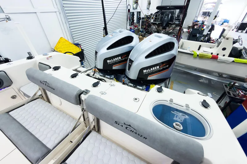 Slide: The Image of 2026 Sea Chaser 27 HFC CC with dual McLaren Performance engines in a workshop setting. - 12