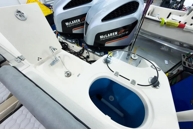 Slide: The Image of 2026 Sea Chaser 27 HFC CC boat interior with McLaren Performance engines and fishing amenities. - 13