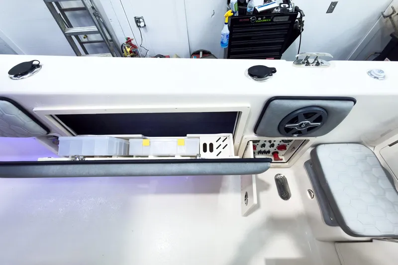 Slide: The Image of Interior view of 2026 Sea Chaser 27 HFC CC boat, featuring storage and control panel. - 15