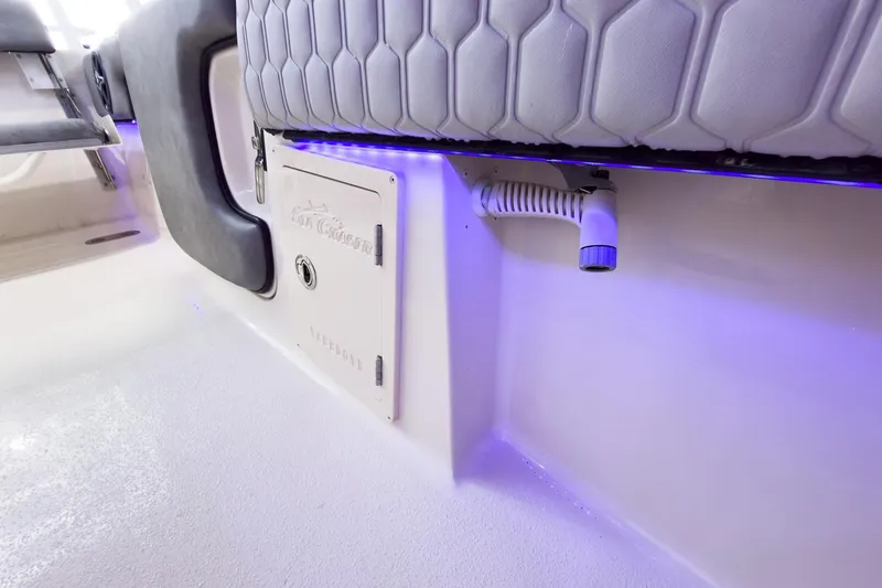 Slide: The Image of Interior view of 2026 Sea Chaser 27 HFC CC boat with blue LED lighting. - 17