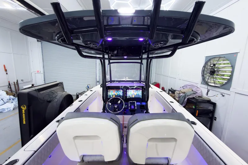 Slide: The Image of 2026 Sea Chaser 27 HFC CC boat interior with modern dashboard and seating. - 19