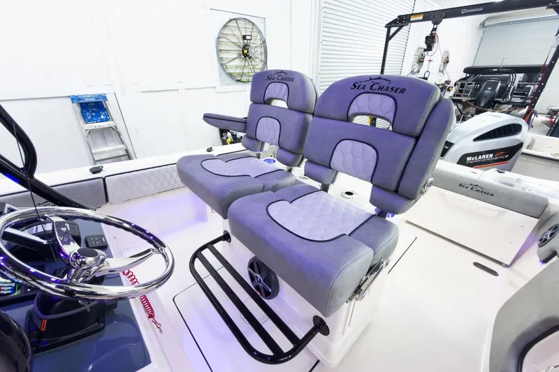 Slide: The Image of Interior of 2026 Sea Chaser 27 HFC CC boat with plush seating and modern steering wheel. - 20