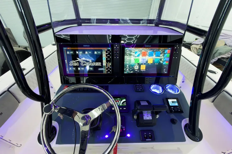 Slide: The Image of Cockpit of 2026 Sea Chaser 27 HFC CC with advanced navigation displays and controls. - 25