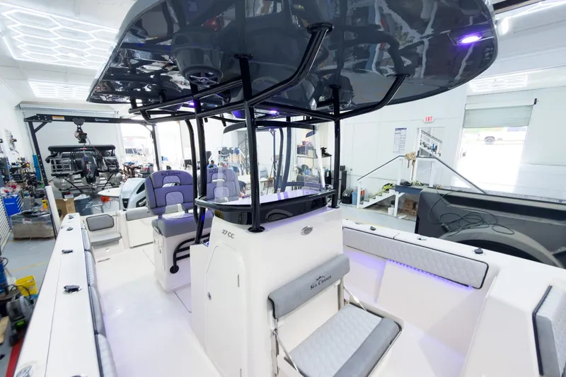 Slide: The Image of 2026 Sea Chaser 27 HFC CC boat interior with modern seating and sleek design. - 28