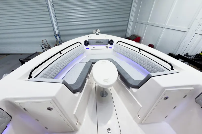 Slide: The Image of 2026 Sea Chaser 27 HFC CC boat interior with cushioned seating and modern design. - 32